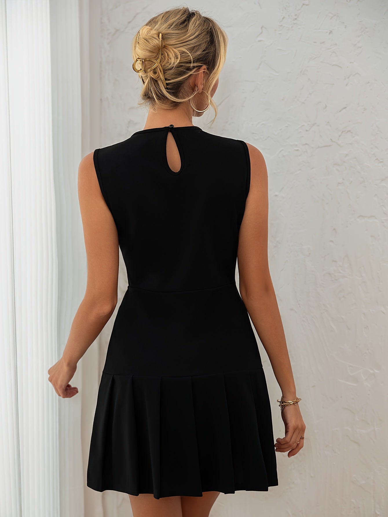 A Black Sleeveless Solid Color Ruffled Mini Dress for Women, Perfect for Birthdays, Parties, And Cocktail Events.