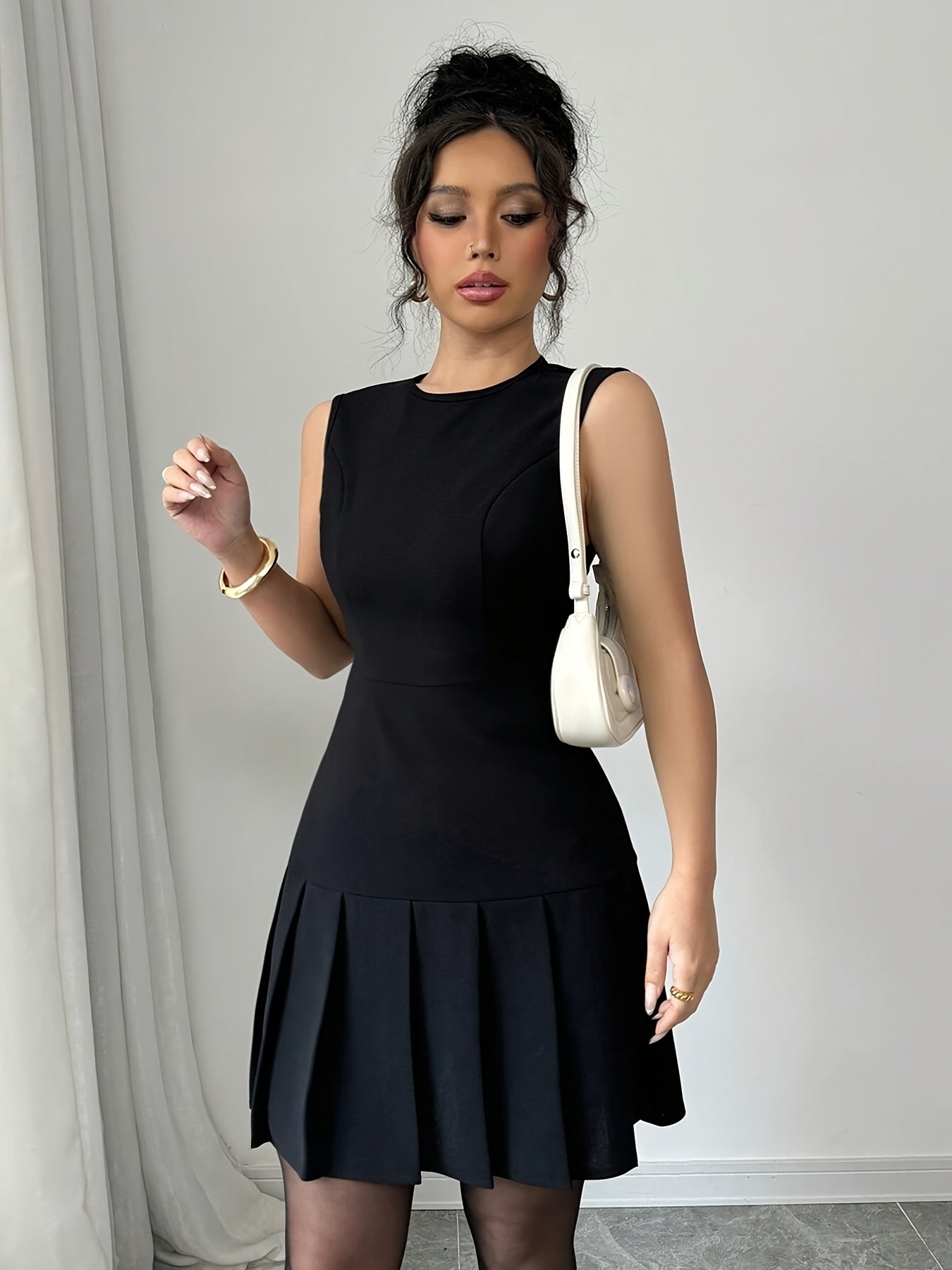A Black Sleeveless Solid Color Ruffled Mini Dress for Women, Perfect for Birthdays, Parties, And Cocktail Events.