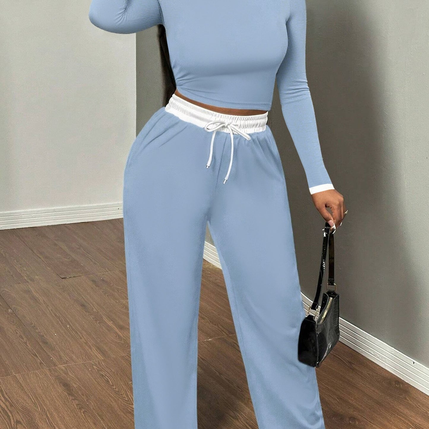 A Two-Piece Set Featuring a Sexy Color-Block Round-Neck Long-Sleeve T-Shirt Paired with High-Waisted Belted Trousers