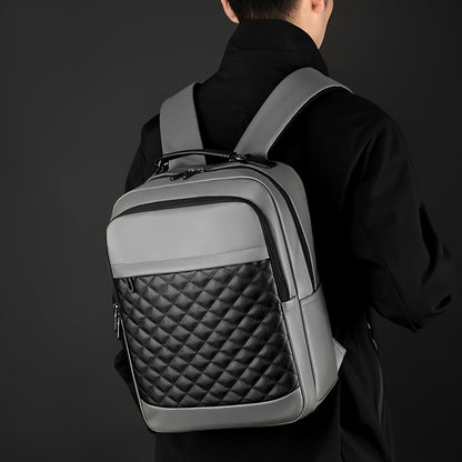 Classic -patterned business backpack, suitable for both men and women. Crafted with high-quality materials, featuring a simple yet elegant design with refined zipper details and spacious compartmentalized storage to showcase